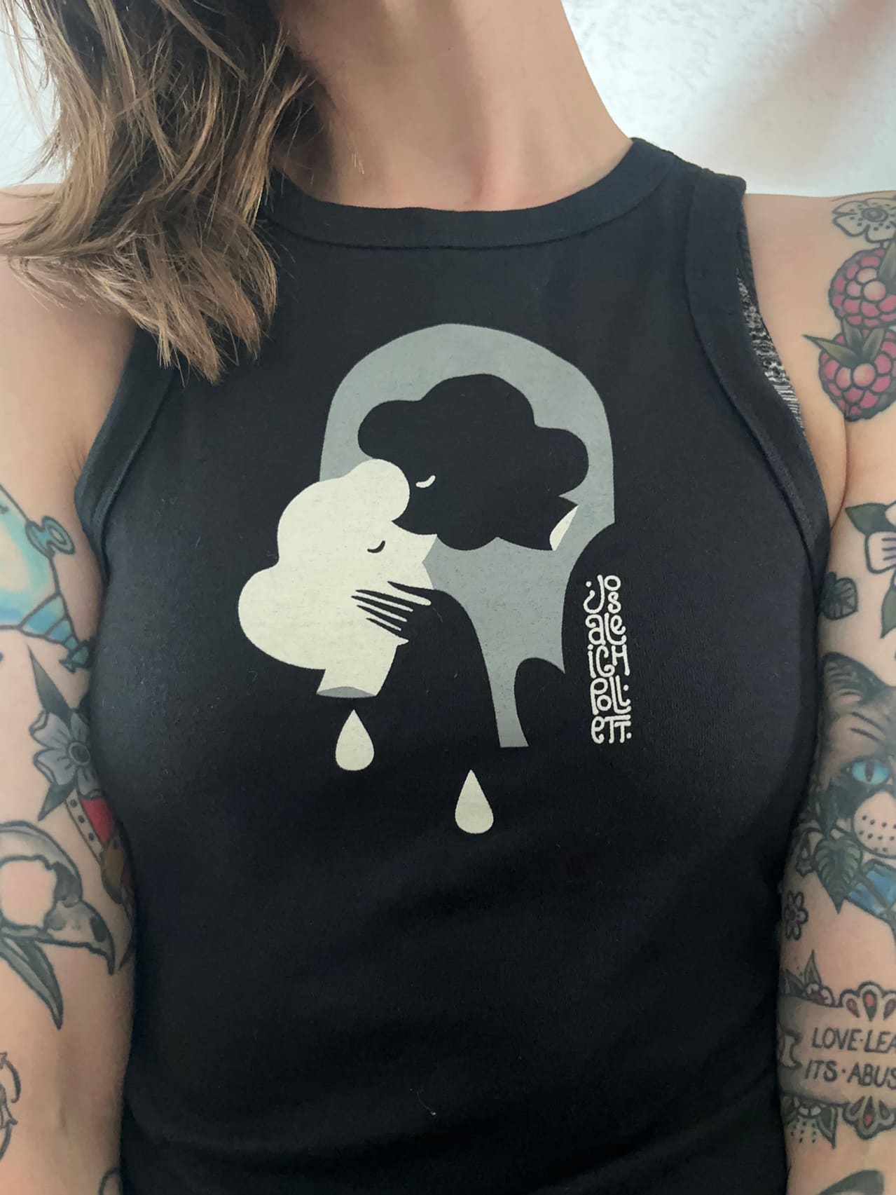 A tank top made for Josaleigh Pollett. Two beheaded figures kiss under an archway shape.