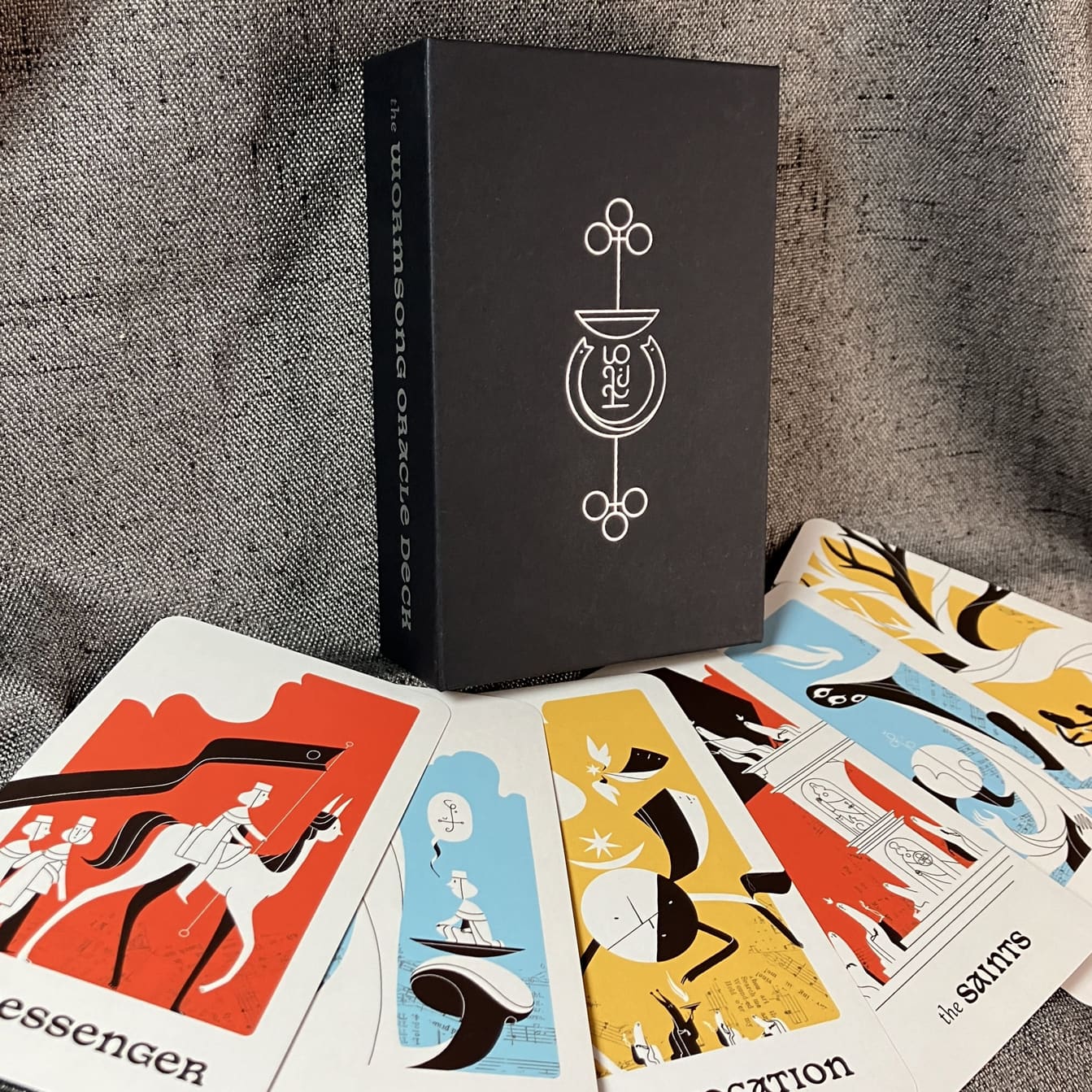 A promotional shot of the Wormsong Oracle Deck, featuring the box and a spread of cards.